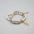 Pearl and gemstone bracelet with a gold leaf charm on a colorful background
